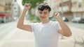 Non binary man listening to music and dancing at park Royalty Free Stock Photo