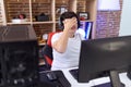 Non binary man streamer stressed using computer at gaming room