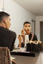 Non binary person applying make-up