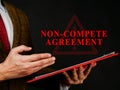 Non compete agreement or clause in red folder. Royalty Free Stock Photo