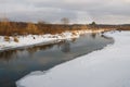 Non-freezing river on winter forest backgrounds Royalty Free Stock Photo