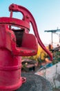 Non-functioning old fashioned red water pump on wooden block Royalty Free Stock Photo