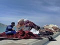 Non recognize fisherman preparing several tools of fishing nets or fishing gear and rope, colorful trawler, seine and surrounding Royalty Free Stock Photo