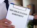 Non solicitation Agreement concept. Manager offers to sign the documents.