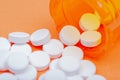 Non-steroidal anti-inflammatory drugs. Acetaminophen white tablets on orange Royalty Free Stock Photo