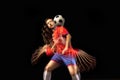 Non stop moving. Young caucasian football soccer player playing in motion in mixed light on dark background.