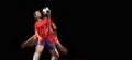 Non stop moving. Young caucasian football soccer player playing in motion in mixed light on dark background.