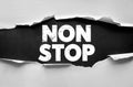 NON STOP phrase displayed in cracked bold font on torn paper surface, expressing motivation, persistence, energy, and continuous Royalty Free Stock Photo
