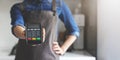 noncash payment - waitress with apron standing in cafe with pos terminal in hand Royalty Free Stock Photo
