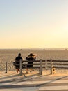 Nondescript couple sitting on a bench off the bike path off Santa Monica Beach Royalty Free Stock Photo