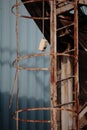 Nonfunctional switch hanging behind a rusted ladder Royalty Free Stock Photo