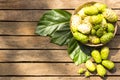 Noni fruit and noni in the basket on wooden table.Top view Royalty Free Stock Photo