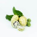 Noni or Morinda Citrifolia fruits with sliced and green leaf on white background