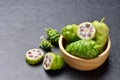 Noni or Morinda Citrifolia fruits with wooden bowl