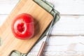 Nonstandard ugly tomato on a kitchen Board on a natural wooden table Royalty Free Stock Photo