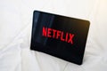 Nonthaburi, THAILAND - April 21, 2020: Netflix logo on Apple ipad lies on a bed. Netflix is a global provider of streaming movies Royalty Free Stock Photo