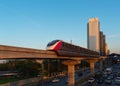 The Pink Line electric train running on train tracks