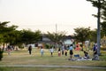 Asian thai family relax play with picnic and people jogging exercise at playground on yard in public garden park Royalty Free Stock Photo