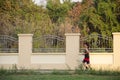 Asian thai people running jogging and exercise in dusk time at public garden park in Nonthaburi, Thailand.