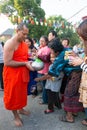 Nonthaburi, THAILAND - Jan 1, 2014 Unidentified Buddhist monks are given food offering from people