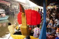 Thai people praying put food and thing offerings to monks procession on boat in tradition of almsgiving at Wat Sai Yai on November Royalty Free Stock Photo