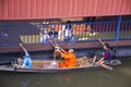 Thai people praying put food and thing offerings to monks procession on boat in tradition of almsgiving at Wat Sai Yai on November Royalty Free Stock Photo