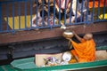 Thai people praying put food and thing offerings to monks procession on boat in tradition of almsgiving at Wat Sai Yai on November Royalty Free Stock Photo