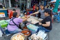 Smile female shopkeeper at street food market shopping in Nonthaburi.