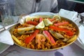 Noodle paella with seafood a bowl on a table.
