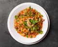 Noodle with pasta, meat, sauce and herbs in a white plate on a dark background, Asian cuisine Royalty Free Stock Photo