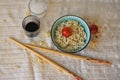 Noodle soop in teabowl, tomatoes, soy sauce, chopsticks