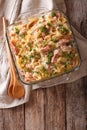 noodles baked with ham and cheese close-up in a baking dish. vertical top view Royalty Free Stock Photo