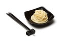 Noodles in black ceramic dish stand on white table background wi Royalty Free Stock Photo