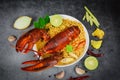 Noodles bowl lobster spicy soup - Cooked seafood with instant noodles soup lobster dinner table and spices ingredients on black Royalty Free Stock Photo