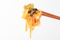 Seasoning cut noodles on a white background