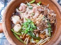 The noodles, generously adorned with succulent pieces of pork and delectable meatballs,