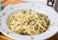 Noodles made with capers, onion, cheese and tuna in olive oil, seasoned with white wine and served in a deep dish decorated with