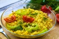 Noodles with vegetables and herbs on the table.