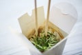 Noodles with pork and vegetables in take-out box on wooden table Royalty Free Stock Photo