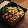 Noodles with pork and vegetables in take-out box on wooden table Royalty Free Stock Photo