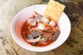 Noodles with seafood on red soup - hot and spicy thai food noodle squid pork fish ball morning glory crispy wonton skin pork and Royalty Free Stock Photo