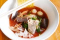 Noodles with seafood on red soup - hot and spicy thai food noodle squid pork fish ball morning glory crispy wonton skin pork and Royalty Free Stock Photo