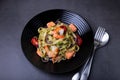 Noodles with seafood, sun-dried tomatoes, capers and red onions. Homemade pasta with shrimp, salmon trout and pesto sauce. Royalty Free Stock Photo