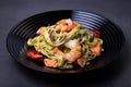 Noodles with seafood, sun-dried tomatoes, capers and red onions. Homemade pasta with shrimp, salmon trout and pesto sauce. Royalty Free Stock Photo