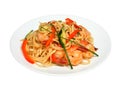 Noodles with shrimps, paprika and zucchini on white round plate Royalty Free Stock Photo