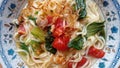 Simple noodle soup with the addition of tomatoes and mustard greens and a sprinkling of chili powder and fried shallots.