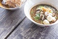 Noodles in Thailand ,Kuay-Teaw-Nam-Tok fastfood of thai on wooden table.Top view and zoom in. Royalty Free Stock Photo