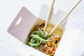 Noodles in a white box on a wooden background close up shot Royalty Free Stock Photo