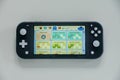 The Nook Miles screen in the game Animal Crossing New Horizons on a Nintendo Switch Lite Royalty Free Stock Photo