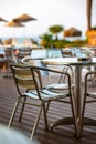 Nook of street cafee with several metal chairs and tables near sea. Royalty Free Stock Photo